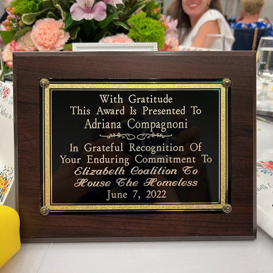 Honoree Plaque for Adriana. It reads: With Gratitude This Award Is Presented To Adriana Compagnoni In Grateful Recognition Of Your Enduring Commitment To Elizabeth Coalition To House The Homeless