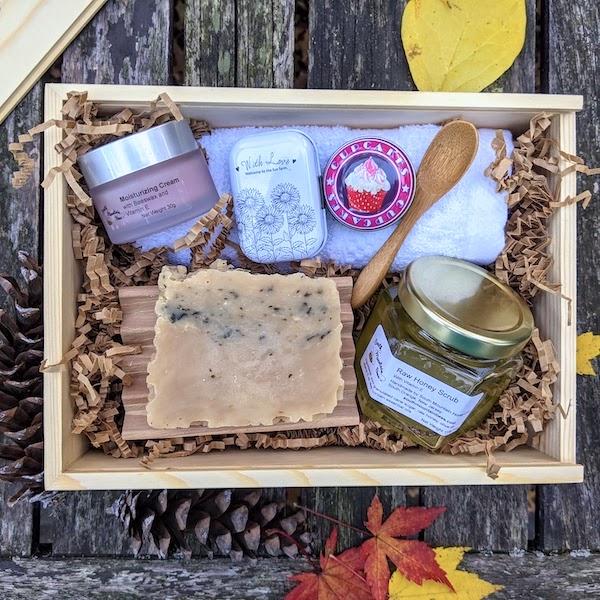 The Giving Gift Set is the top of the line. It contains: moisturizing cream with Shea butter, beeswax and vitamin E, raw honey scrub with bamboo spoon, handcrafted honey soap, beeswax lip balm, soothing salve, beech wood soap dish, and a hotel grade 100% cotton washcloth, in reusable sliding top wooden box.