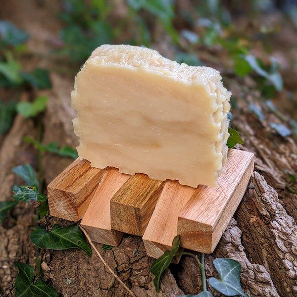 This is our honey soap. It is one of our best sellers. It is displayed here on a wooden soap dish made of recycled wood which we also sell in the store.