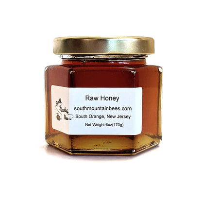 6oz jar of delectable dark amber honey in glass jar with golden lid.