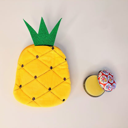 Adorable pineapple coin purse with open lip balm tin.