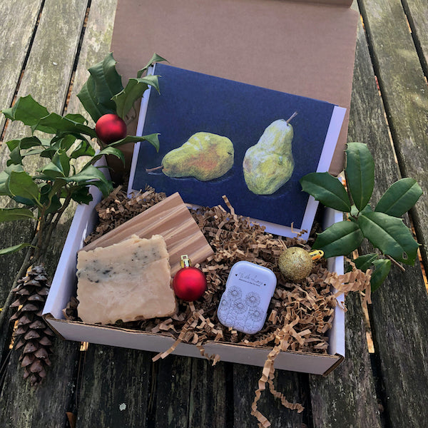 A gift box with a honey soap, a wooden soap dish, a salve, and a set of 4 cards: pears.