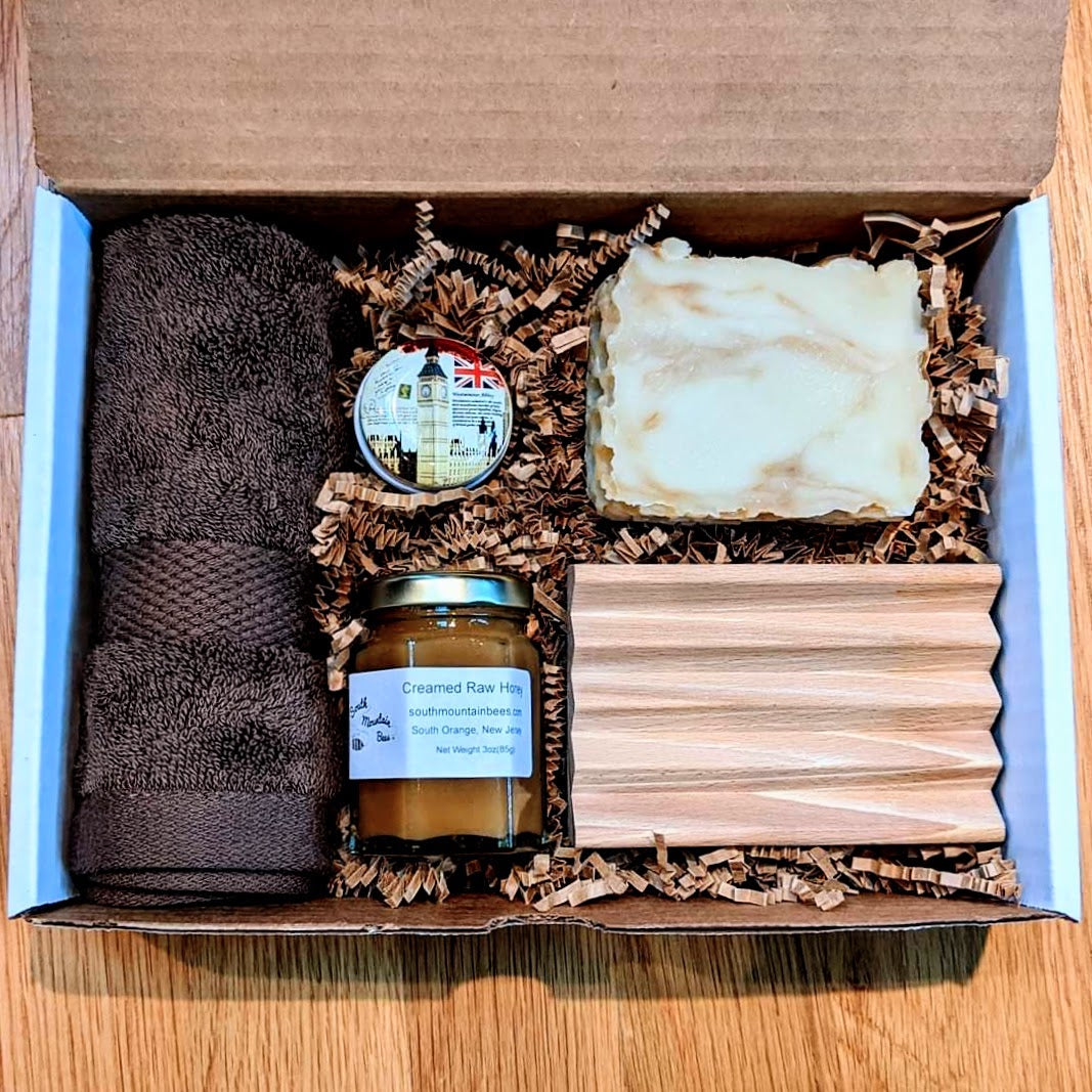 A gift box with three of our best sellers: a soap, a lip balm, and a jar of honey,  together with a beech soap dish and a soft 100% cotton washcloth.
